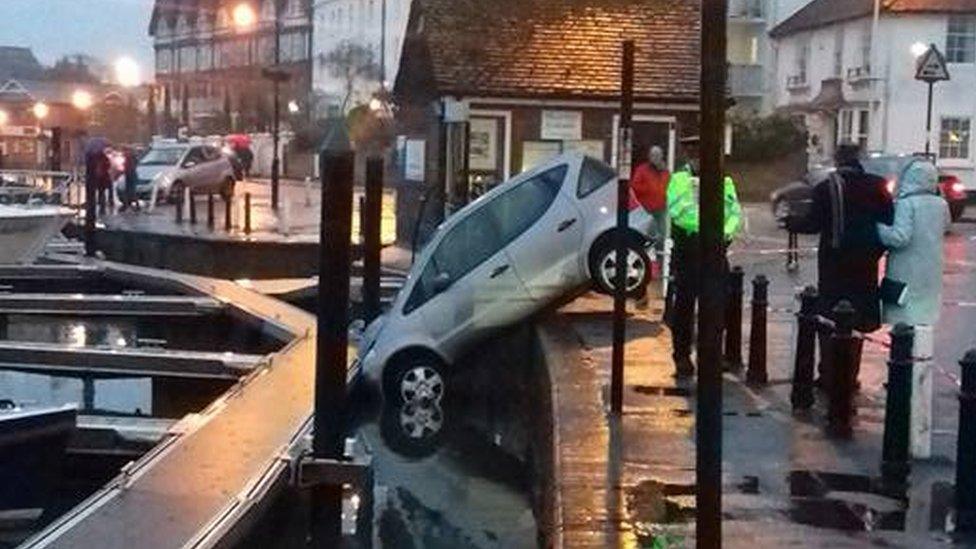 Car weddged into river