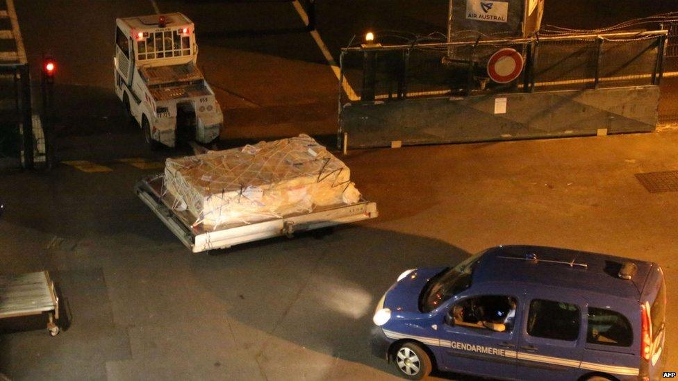 Police escort airport vehicle transporting debris at Saint-Marie's airport on Reunion. 31 July 2015