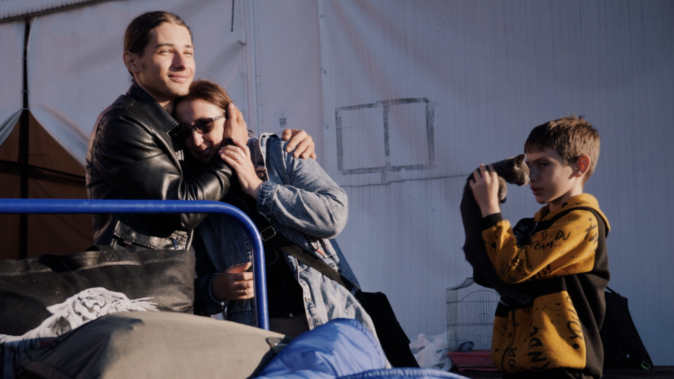 Maksym Bezhan, his mother, brother and the family cat