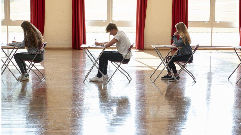 pupils sitting in school exam hall