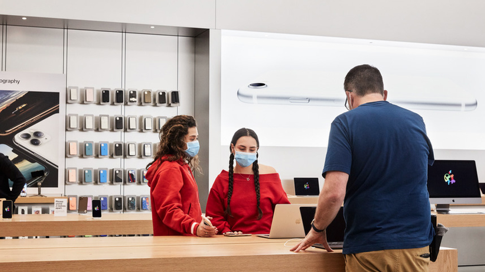 Apple store with customers wearing masks