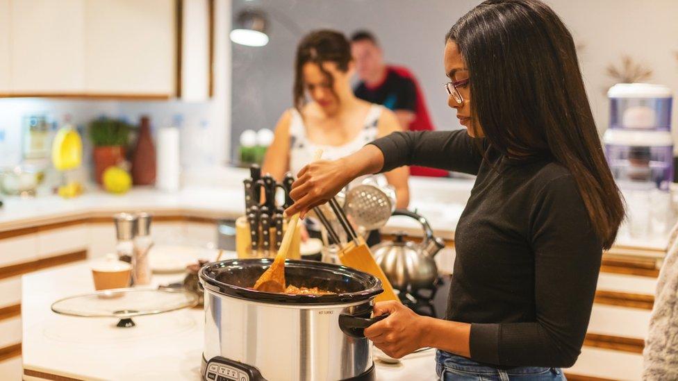 Woman with slow cooker