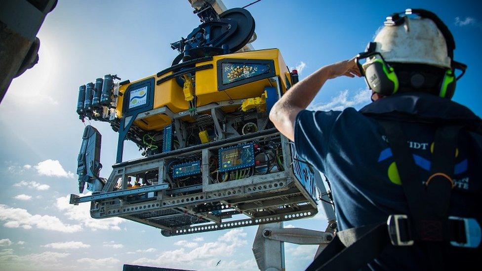 The remotely operated vehicle SuBastian is moved into position on the research vessel