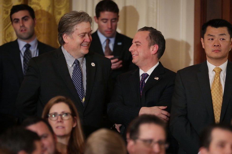 White House officials watch the East Room announcement