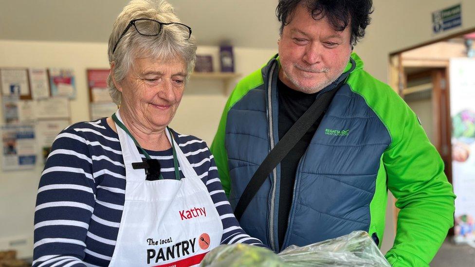 a woman and man looking at food