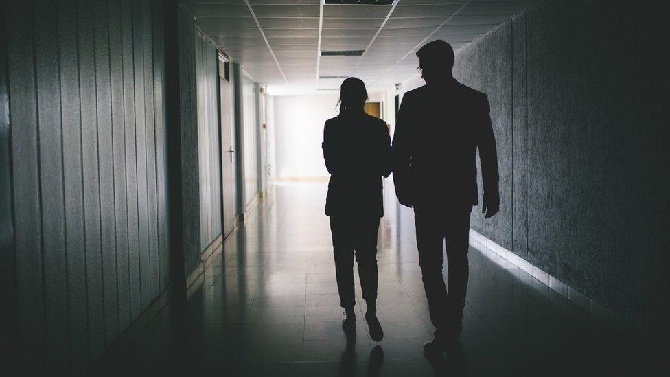 Silhouette of a man and a woman at work