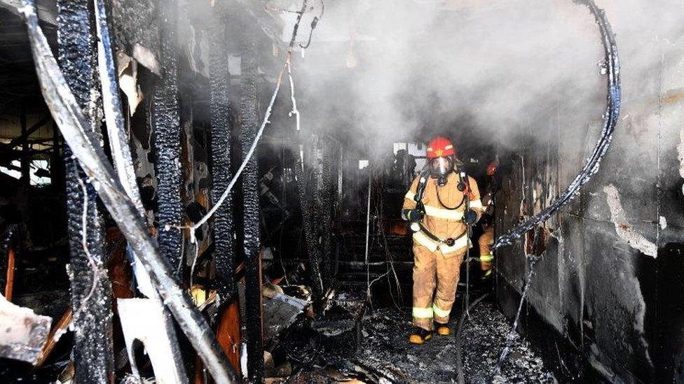 A firefighter inspects the gutted hospital in Miryang. Photo: 26 January 2018