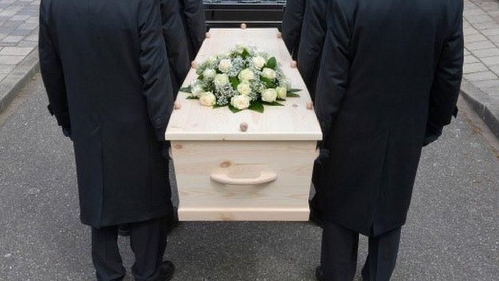 Pallbearers and coffin