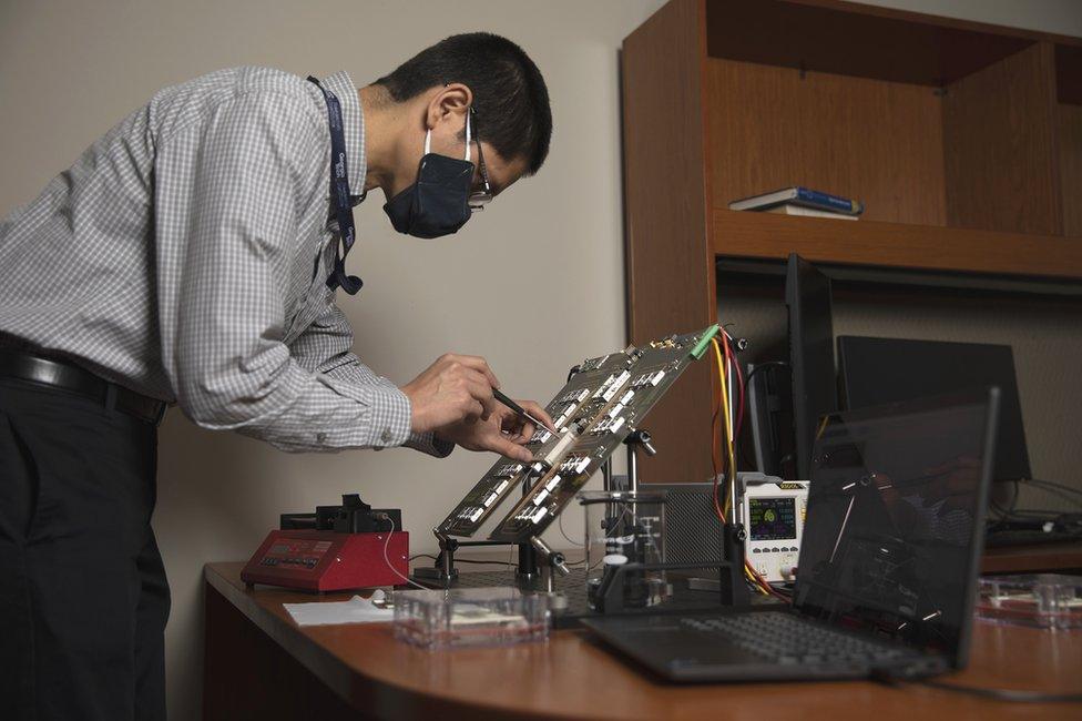 GTRI's Nicholas Guise tests electronics on the microchip