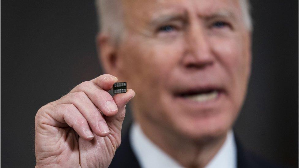 President Biden holding a semiconductor