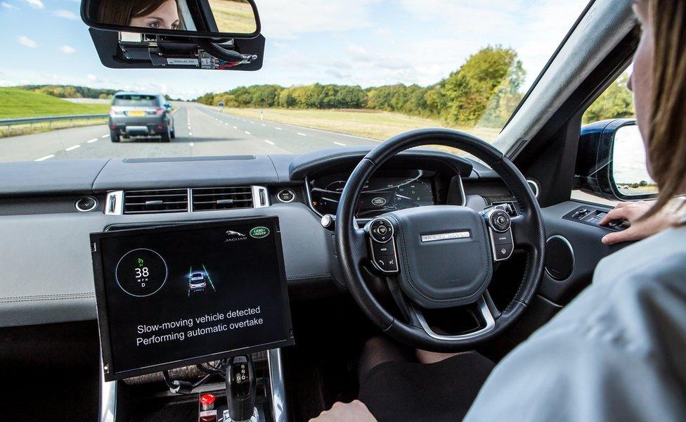 A screen showing that the car is about to overtake a vehicle in front