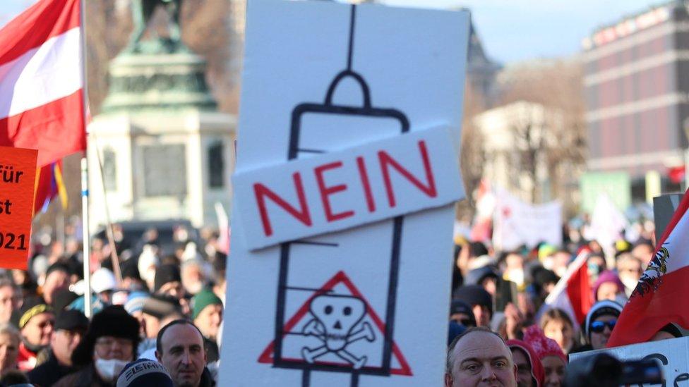 People holding placards gathered at Heldenplatz to protest the government's Covid-19 measures in Vienna, Austria on 8 January