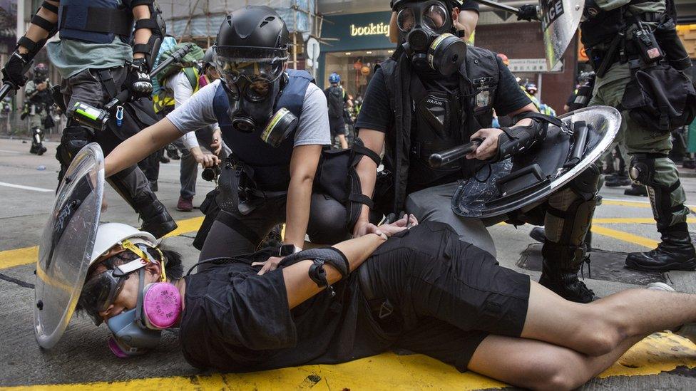 Police hold down a detained protester in Hong Kong (1 Oct 2019)