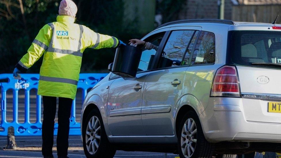 NHS Test and Trace worker collects test sample