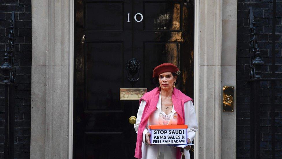 Human rights advocate Bianca Jagger delivers a petition urging the UK government to halt arms sales to Saudi Arabia and to free jailed Saudi blogger Raif Badawi at 10 Downing Street in London on March 15, 2017