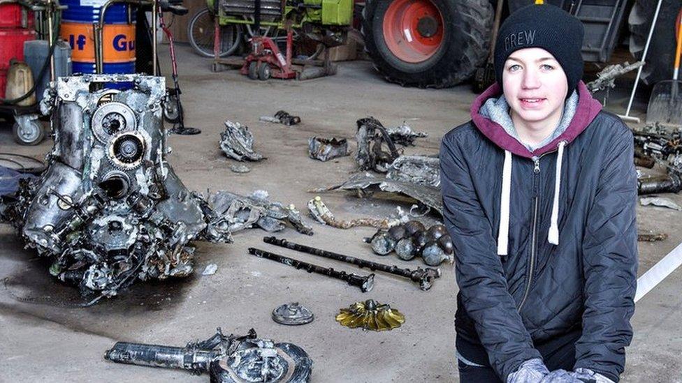 Daniel Kristensen poses with debris from the wreck of a World War II aircraft, which he and his father found yesterday near Birkelse by Aabybro in Northern Jutland