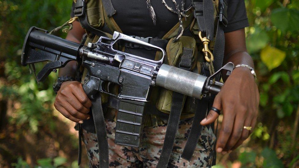 A female guerrilla fighter of the Western Front of War Cimarron Resistance of the National Liberation Army (ELN) guerrilla, stands guard during an interview with AFP, on January 26, 2017, in Alto Baudo