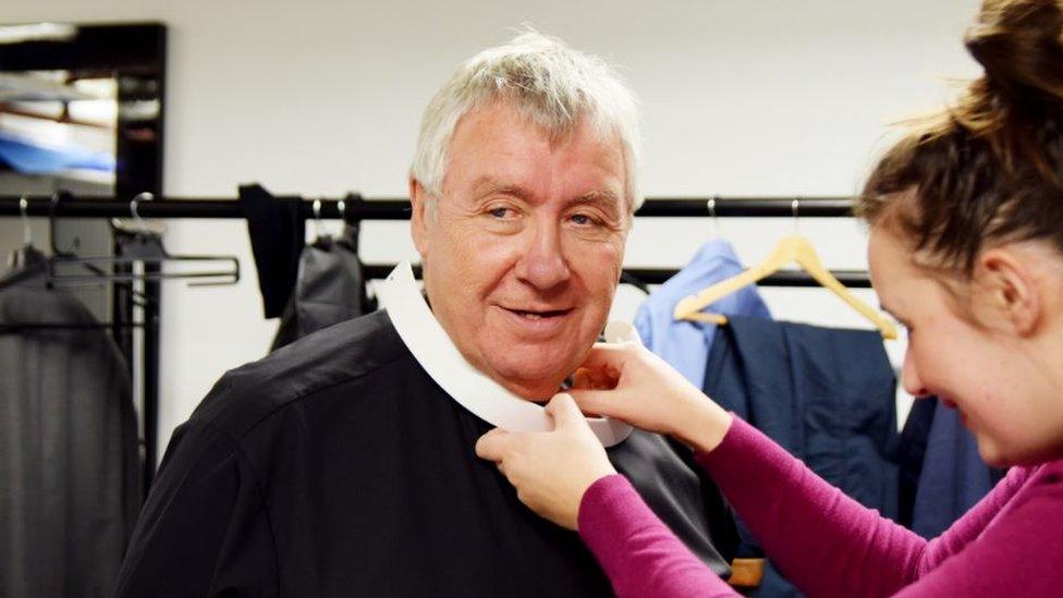 Gregor Fisher tries on the dog collar