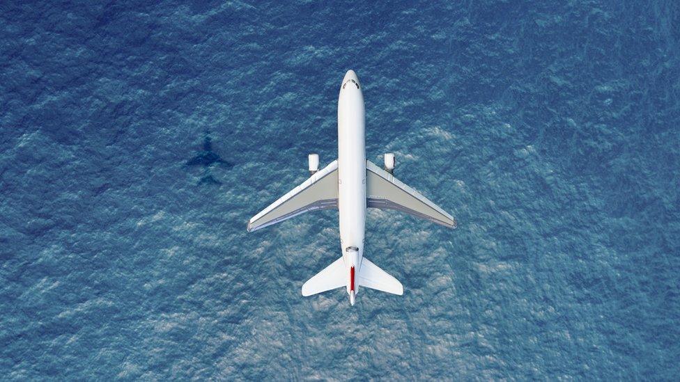 A plane flying over a sea