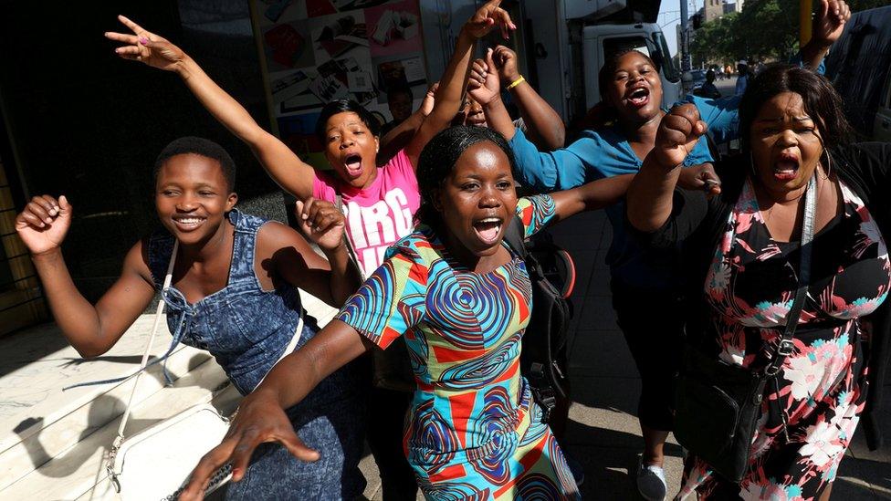 Zimbabweans celebrate in the morning sun after President Robert Mugabe resigned in Harare, Zimbabwe, November 22, 2017