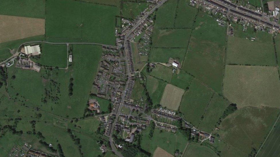 Aerial view of a village surrounded by fields