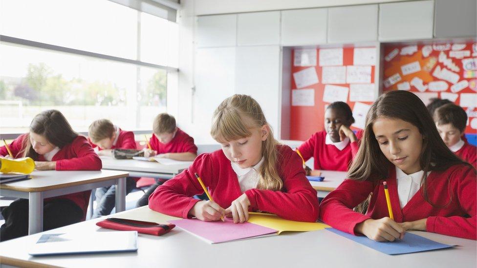 Students writing in classroom