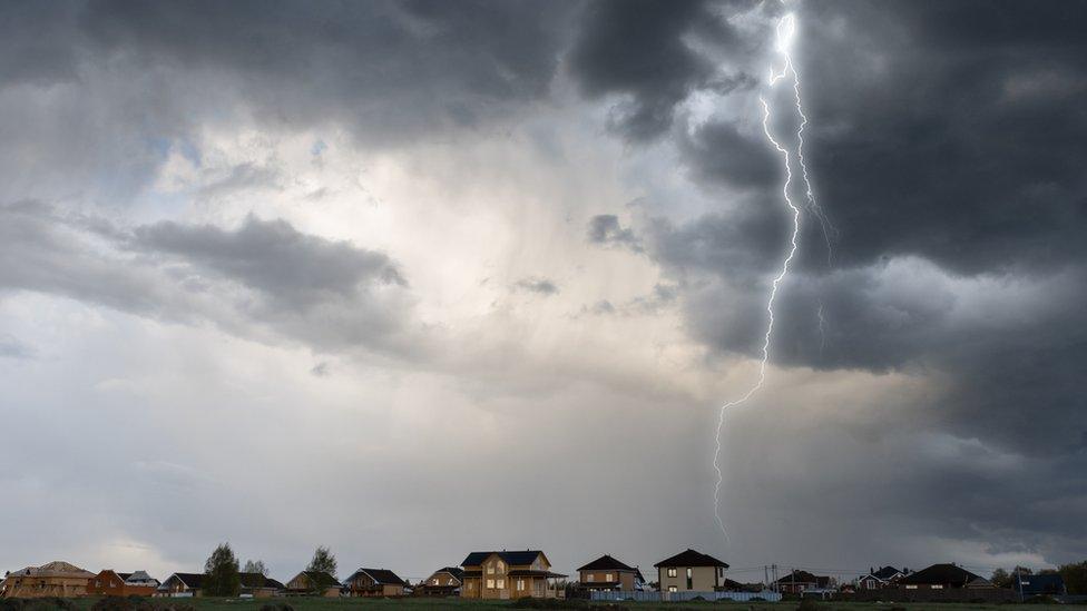 Cloud storm sky with thunderbolt over the village in rural scene