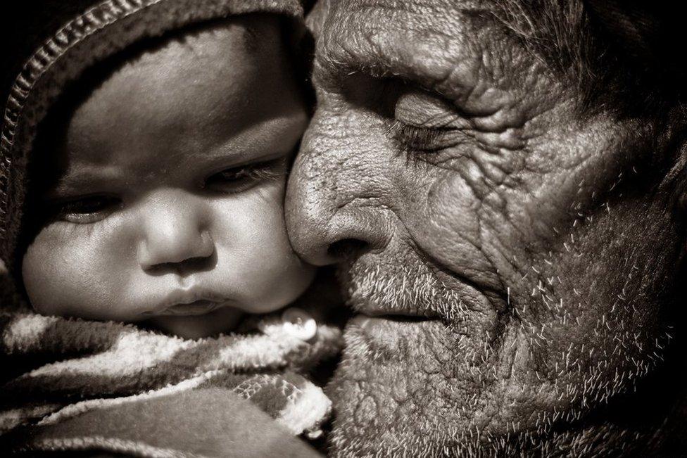 An old man playing with his great grandson in a small village near Udaipur