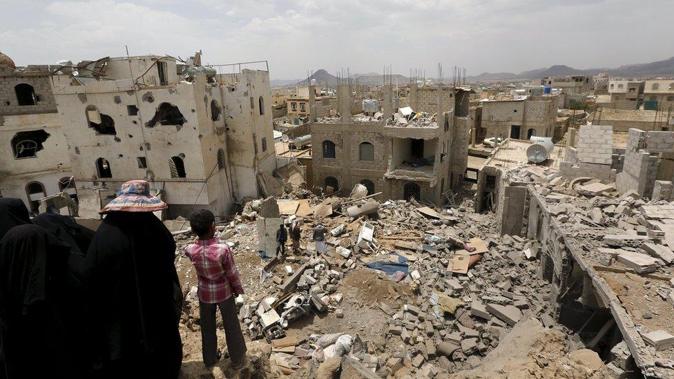 People look at the rubble of houses destroyed by a Saudi-led air strike in Yemen's capital, Sana'a