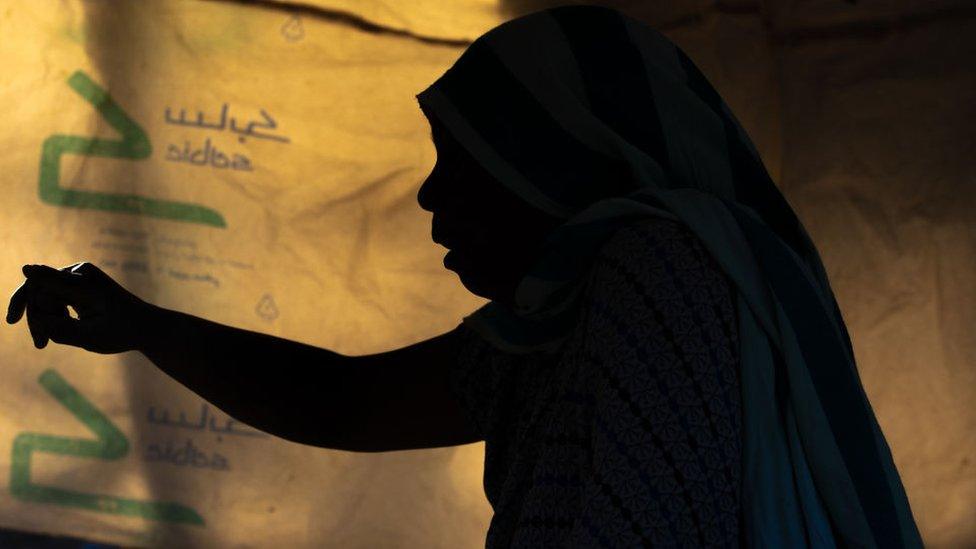 A silhouette of an anonymous woman at a market in Amhara, in 2018.