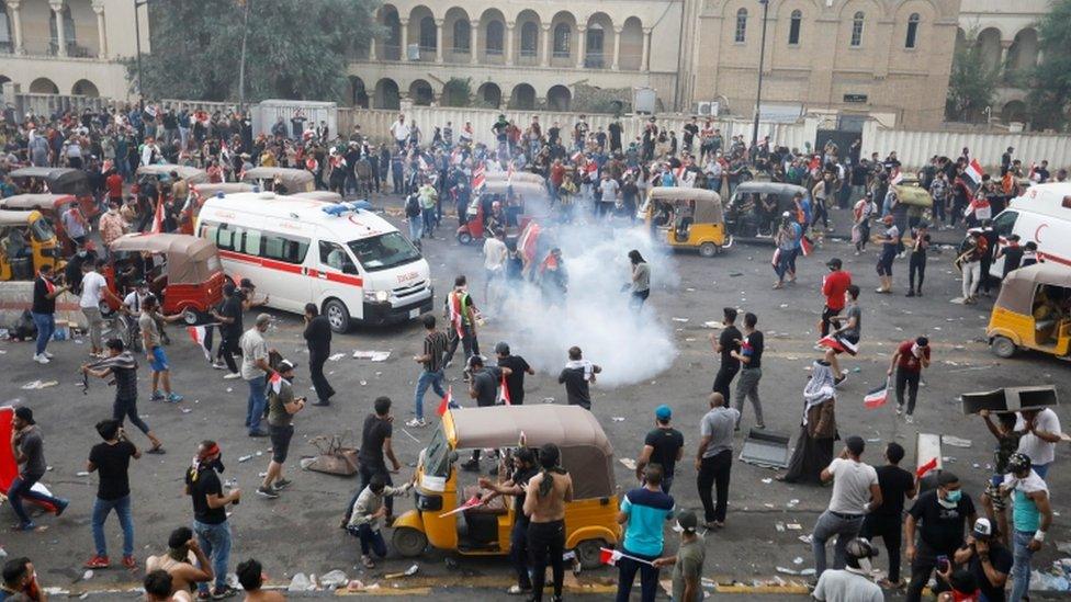 Demonstrators disperse as Iraqi security forces use tear gas in Baghdad