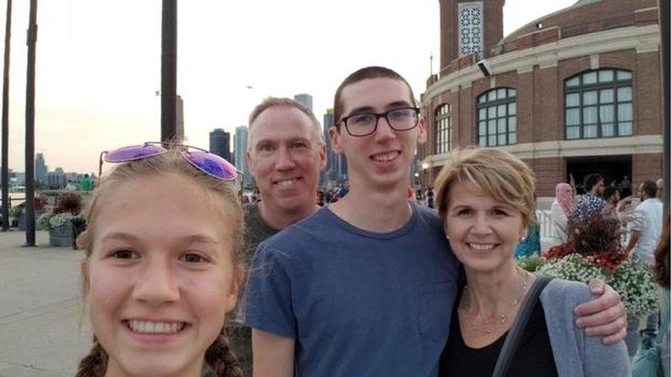 A photograph of Alex Kearns, his parents and younger sister