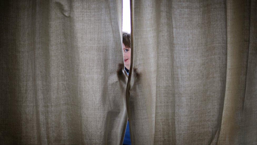 boy-closing-curtains.