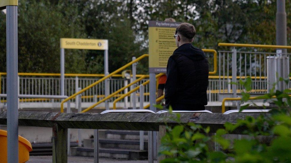 Teenager at tram stop