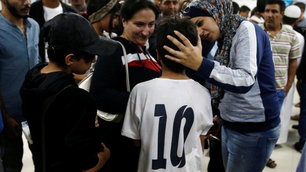 A child survivor is seen with relatives in a hospital near the Dead Sea, Jordan October 25, 2018