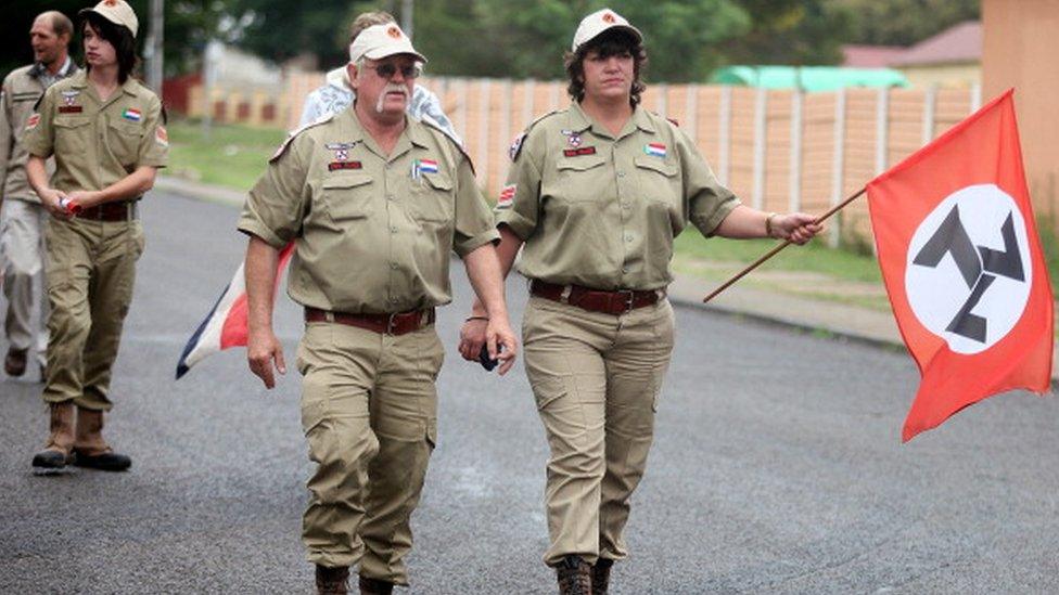 Supporters of the white supremacist Afrikaans Resistance Movement (AWB) arrive on November 22, 2010 at the Ventersdorp magistrate court for the trial of a 15-year-old minor and his co-accused Chris Mahlangu, 28, charged with hacking to death the 69-year-old leader of the AWB, Eugene Terre'Blanche, in April.