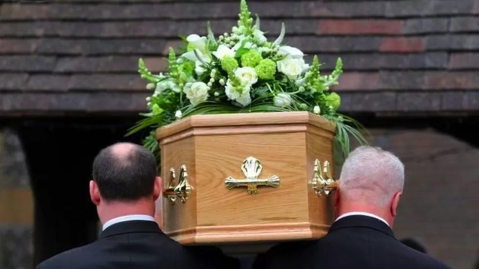 a coffin being carried