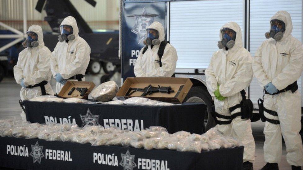 Mexican police display drugs and weapons seized from the Sinaloa cartel