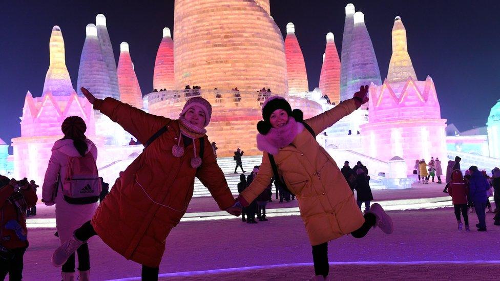 Visitors posing in front of one of the many sculptures