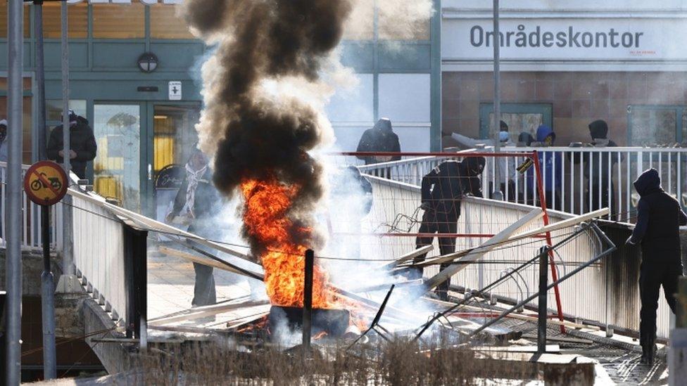 Protesters set fire to a barricade in Norrköping