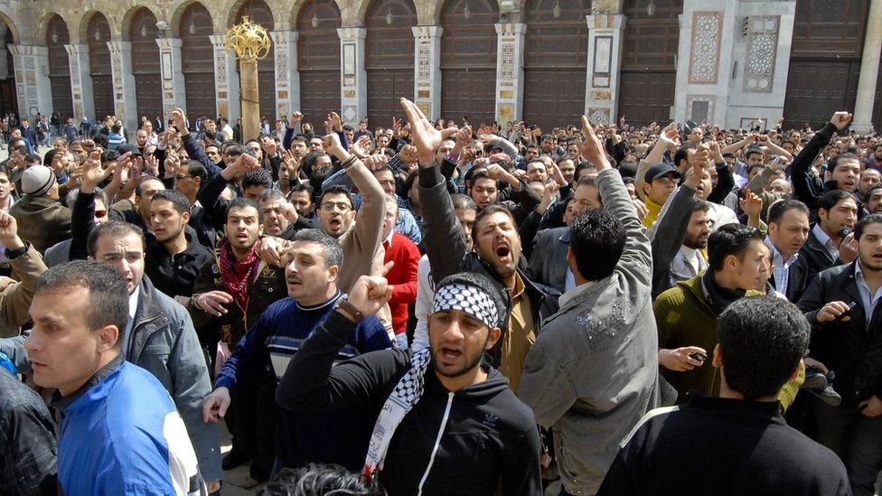 Anti-Assad protesters shout slogans after Friday prayers outside the Umayyad Mosque in Damascus, Syria (25 March 2011)