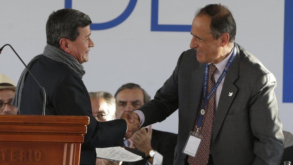 Colombia's government representative Juan Camilo Restrepo, right, shakes hands with National Liberation Army (ELN) representative Pablo Beltran during a ceremony marking the start of formal peace talks in Quito, Ecuador,