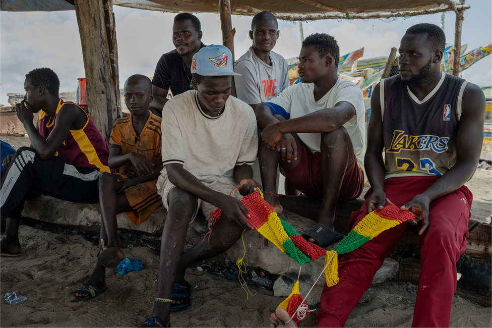 A group of young fishermen on the beach in Fass Boye.