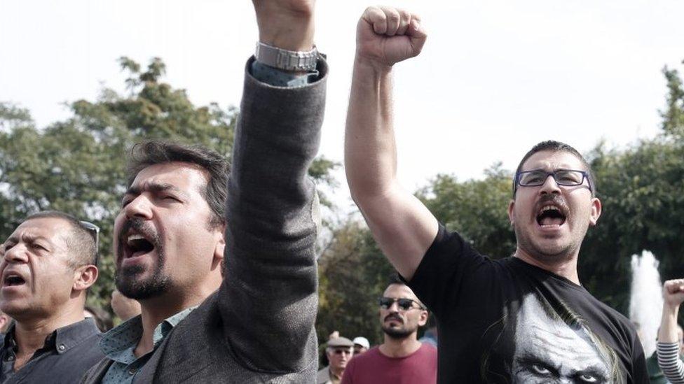 Protesters shout slogans against the Turkish government as they hold pictures of victims during a demonstration the day after a twin blast in Ankara (11 October 2015)