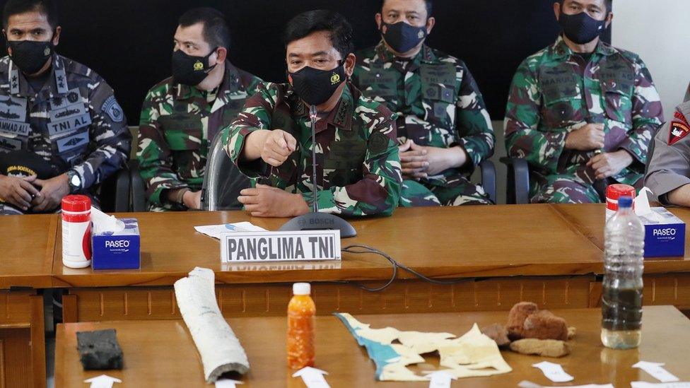 Indonesian naval officers with debris believed to be from the missing Indonesian sub - Bali, 24 April