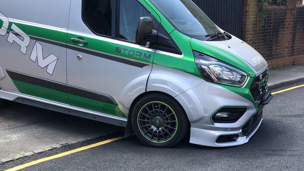 A van scraping on a road