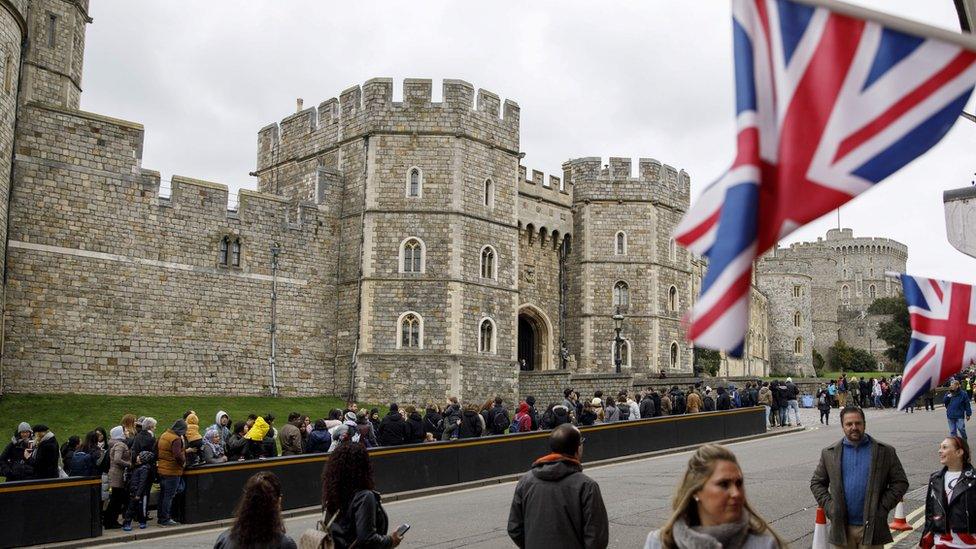 Tourists outside Windsor Castle, where Prince Harry and Meghan Markle will marry on 19 May