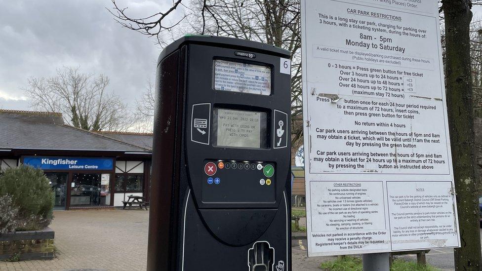 A parking meter outside a leisure centre.