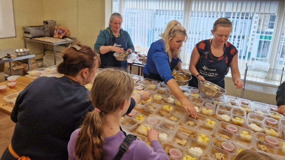 Volunteers preparing breakfast boxes