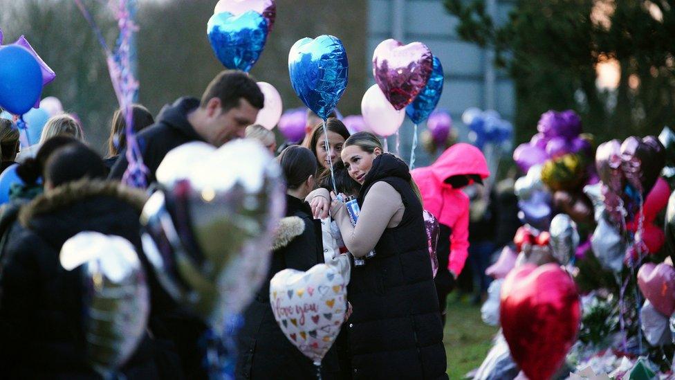 People hugging at vigil